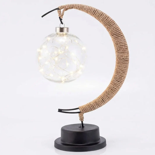 Decorative lamp with a round glass shade, woven arm, and black base on a white background