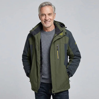 Man wearing a green and black jacket on a light gray background